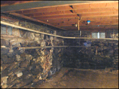 Rim joist and rafters with rot damage before foaming