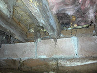 Rim joist and rafters with rot damage before foaming