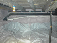 Crawlspace after the installation of vapor retarder and foam insulation