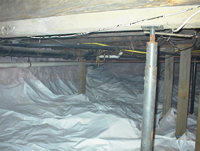 Crawlspace after the installation of vapor retarder and foam insulation